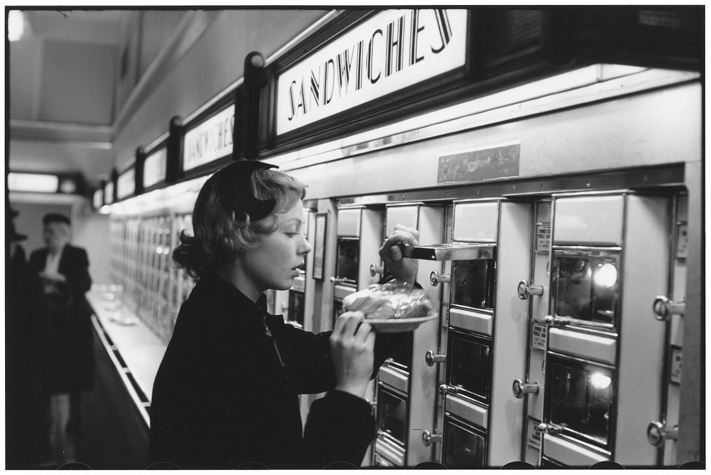 Elliott ERWITT, French actress Dany ROBIN at an automat, New York City, USA
1953